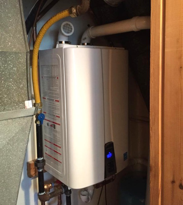 new tankless water heater installed in the basement of a home in michigan