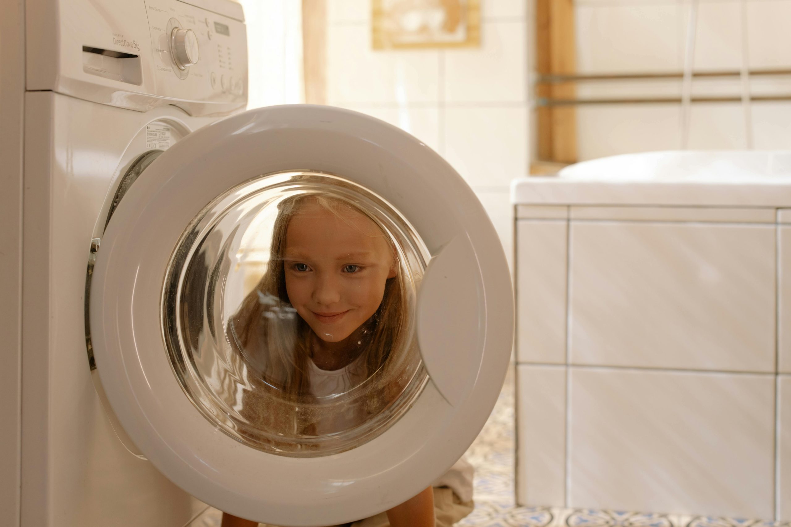 pexels-cottonbro-7086372 girl looking through washer machine